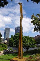 Very tall steel sculpture that looks like an abstract standing person.